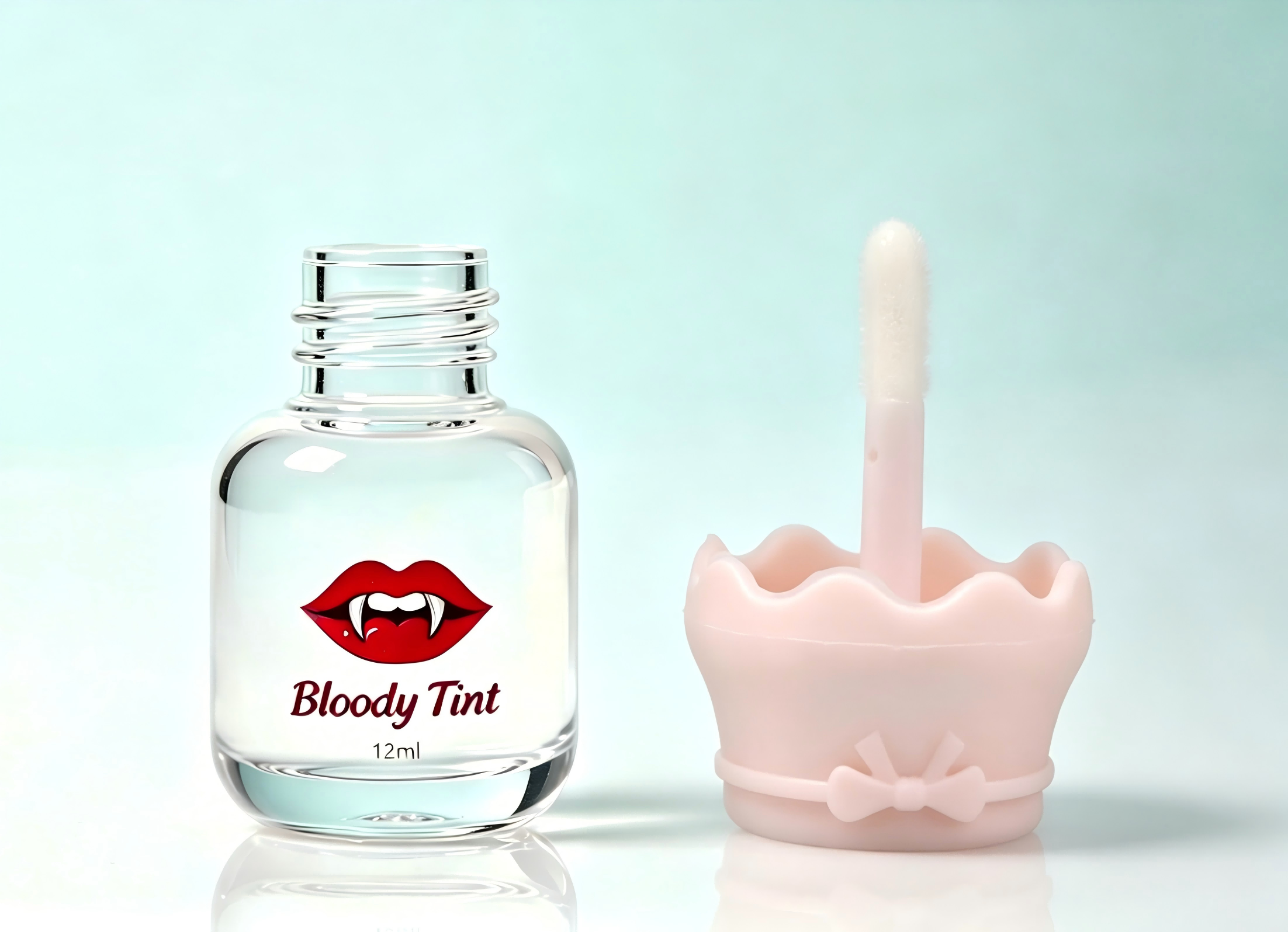 Cute mini lip gloss tube with pink scalloped bow cap and custom vampire lip logo print for lip tint packaging